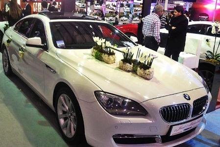 The White BMW 6 series 4 doors decorated for weddings