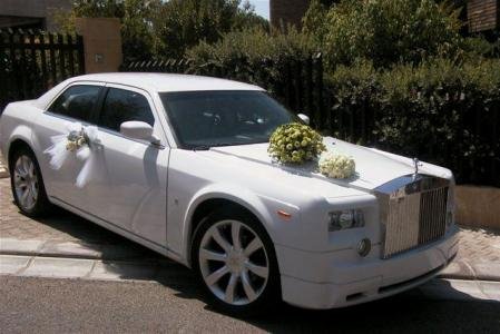 Chrysler wedding car with a phantom look decorated in flowers