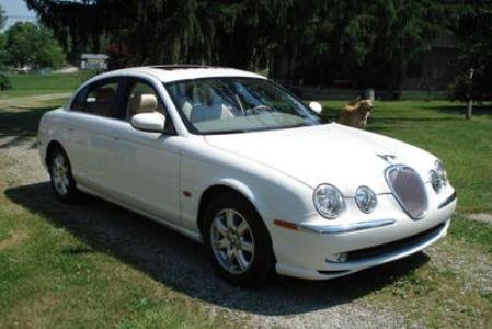Jaguar S Type parked in a green field
