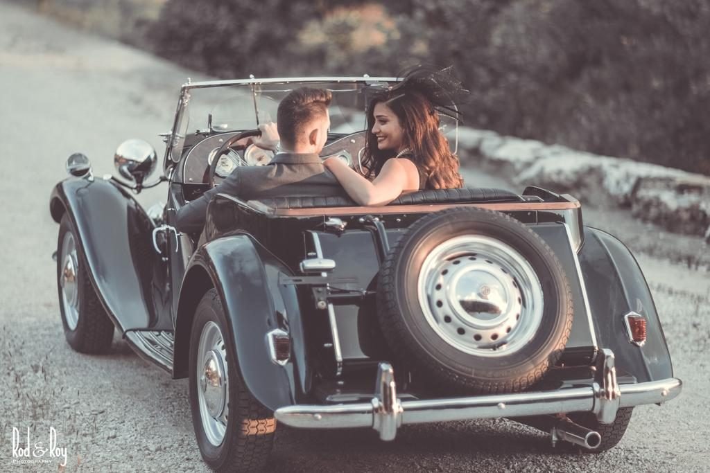 Couple posing next to the MG 1949 Roadster