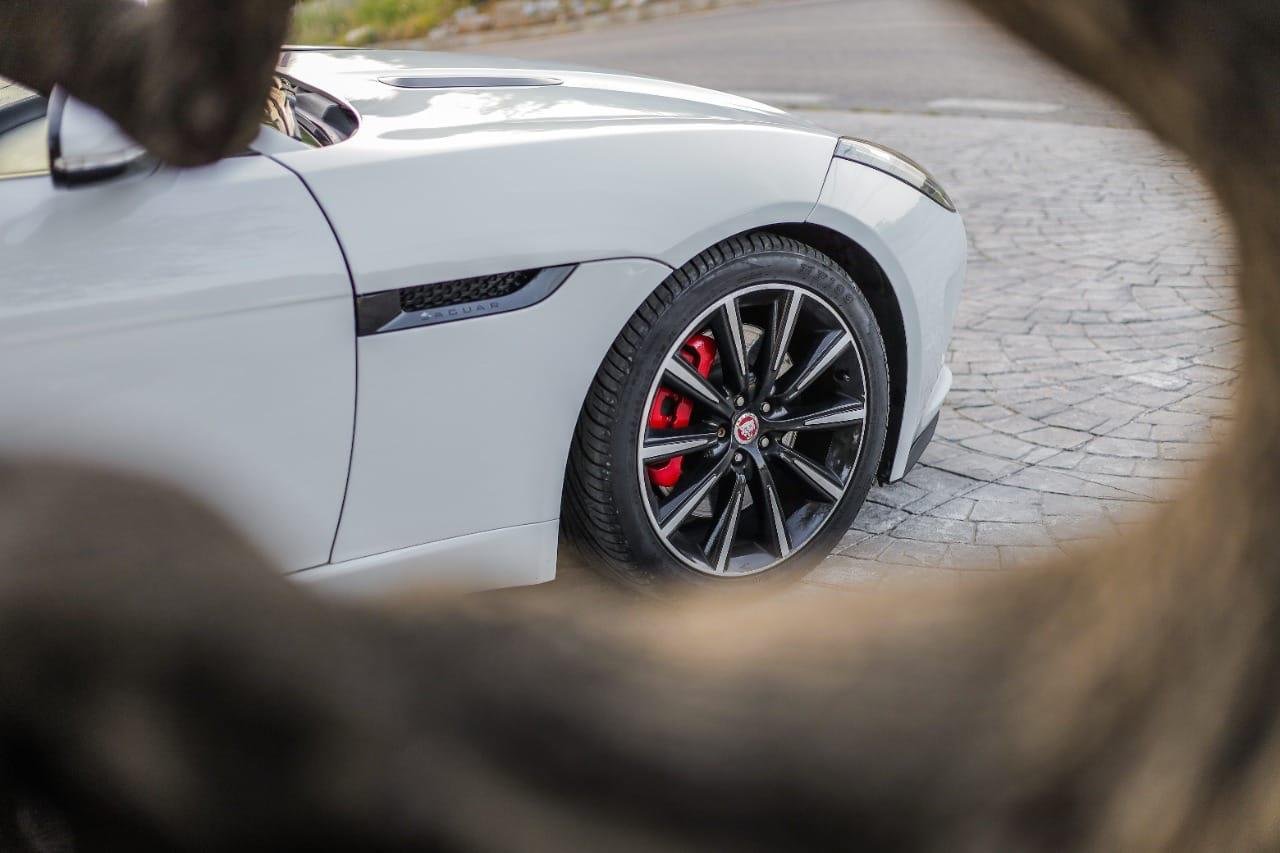 A side angle picture of a luxury car for taxi rental with driver