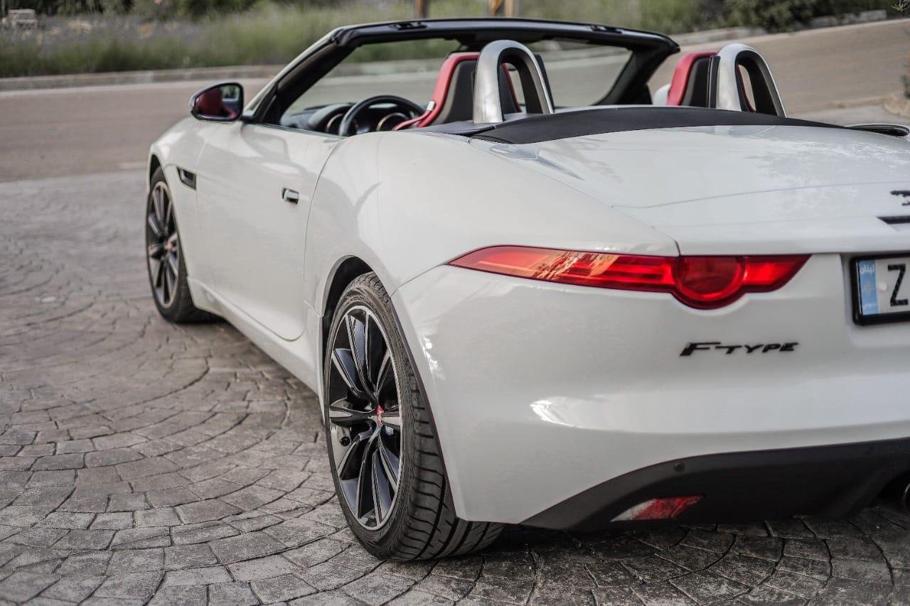 The white F type jaguar convertible from the back