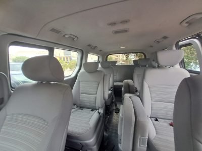 The interior of the black H1 Mini Bus with all 10 seats and their cup holders