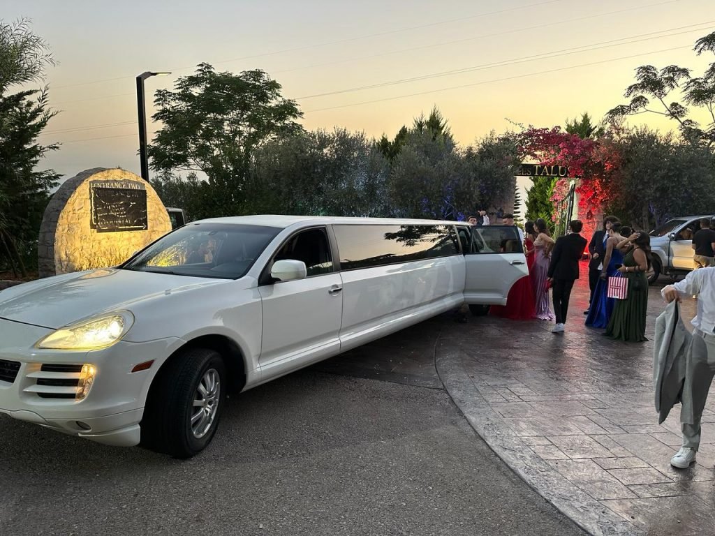 Porsche stretch luxury limo with school prom students nicely dressed and posing next to it
