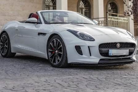 Convertible wedding car rental Jaguar F Type next to a beautiful building in Beirut