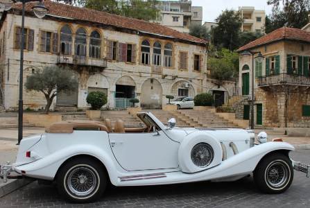 Excalibur convertible wedding car next to a traditional house in Ain Aar Village Lebanon