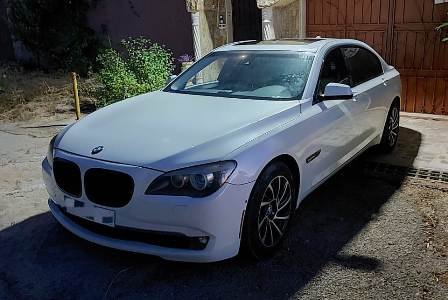 Luxury Taxi BMW parked next to a Lebanese house in a village