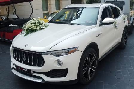 Luxury taxi Maserati Levante in front of a luxury building in Beirut