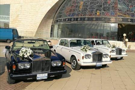 The 3 Rolls Royce parked next to each other in front of a majestic church in Lebanon